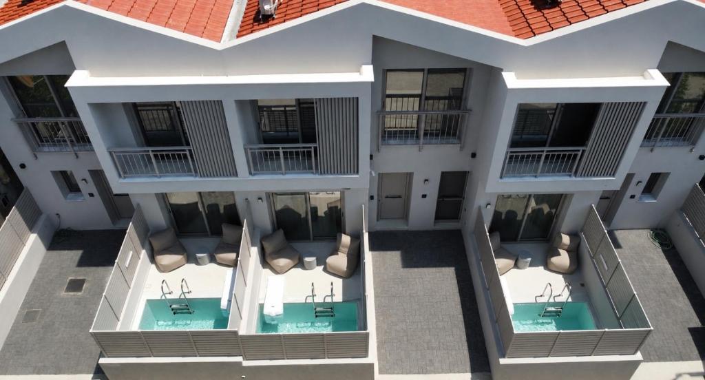 an aerial view of a building with a swimming pool at LaK Private Pool Suites in Potos,Thassos in Potos