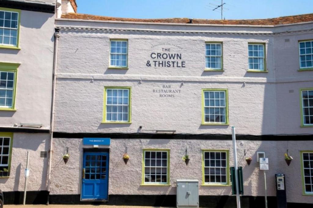 a building with a sign for the crown and whistle at The Crown & Thistle, Abingdon, Oxfordshire - Acorn Pubs in Abingdon