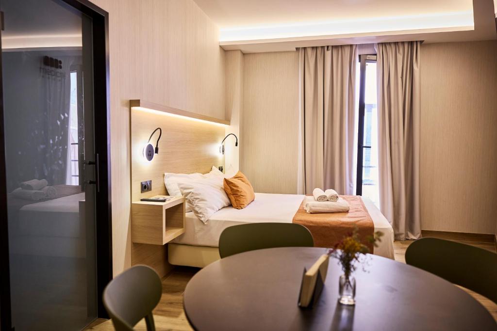 a hotel room with a bed and a table at Medichë Rooms General Ricardos in Madrid