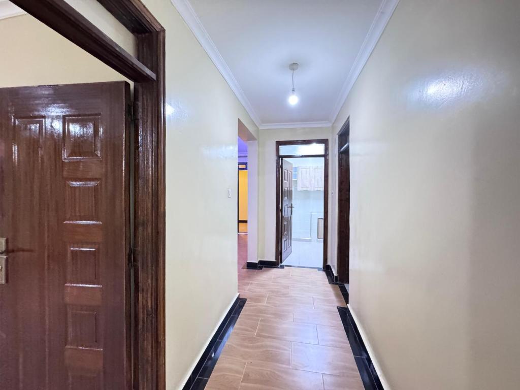 a hallway with a door and a tile floor at Riverview greenstar cozy homes in Kisii