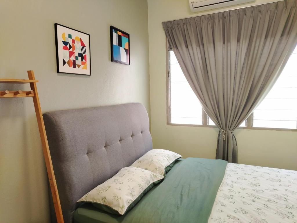 a bedroom with a bed and a window at SS Ipoh Comfort Homestay - Taman Bertuah in Ipoh