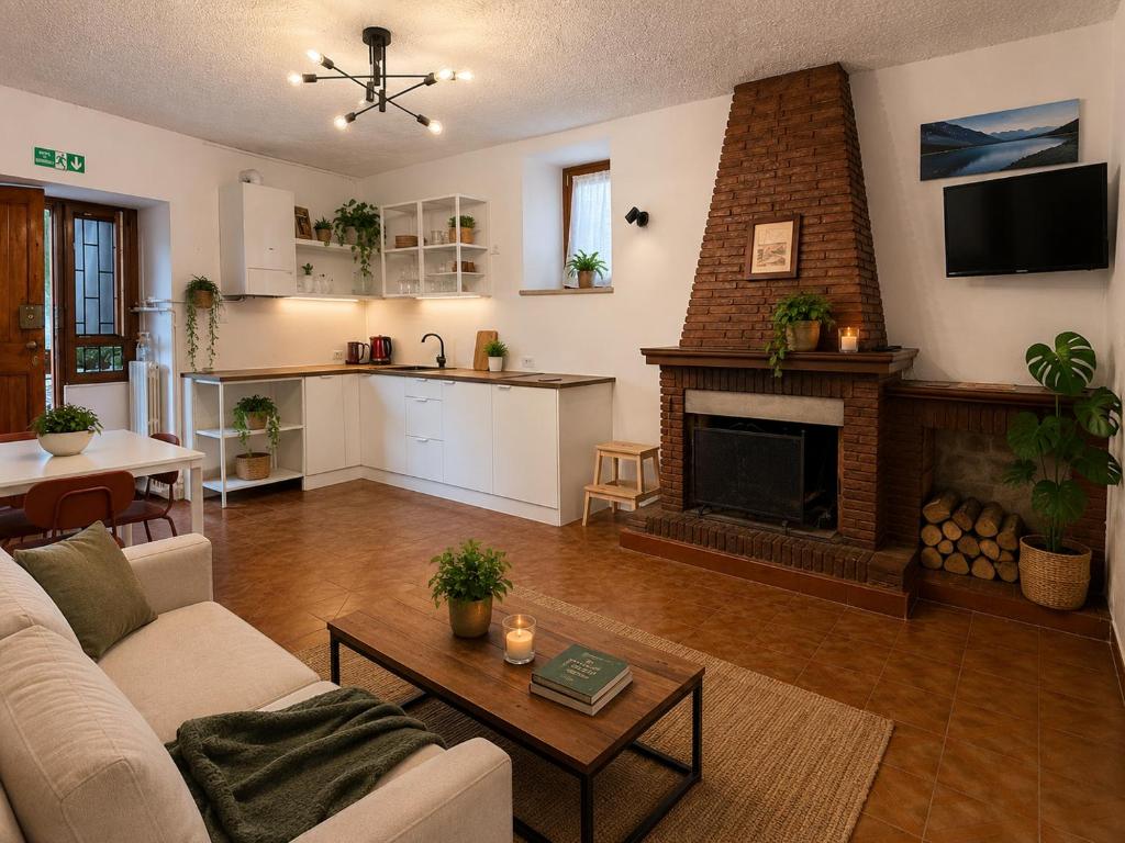 a living room with a couch and a fireplace at Il Focolare in Subiaco
