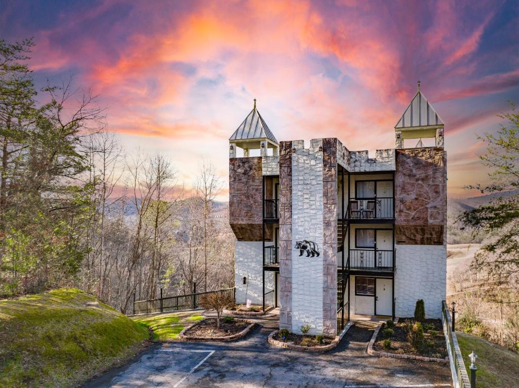 a building on a hill with a sunset at Mountain Views at Dolly's Castle Unit 3 in Sevierville