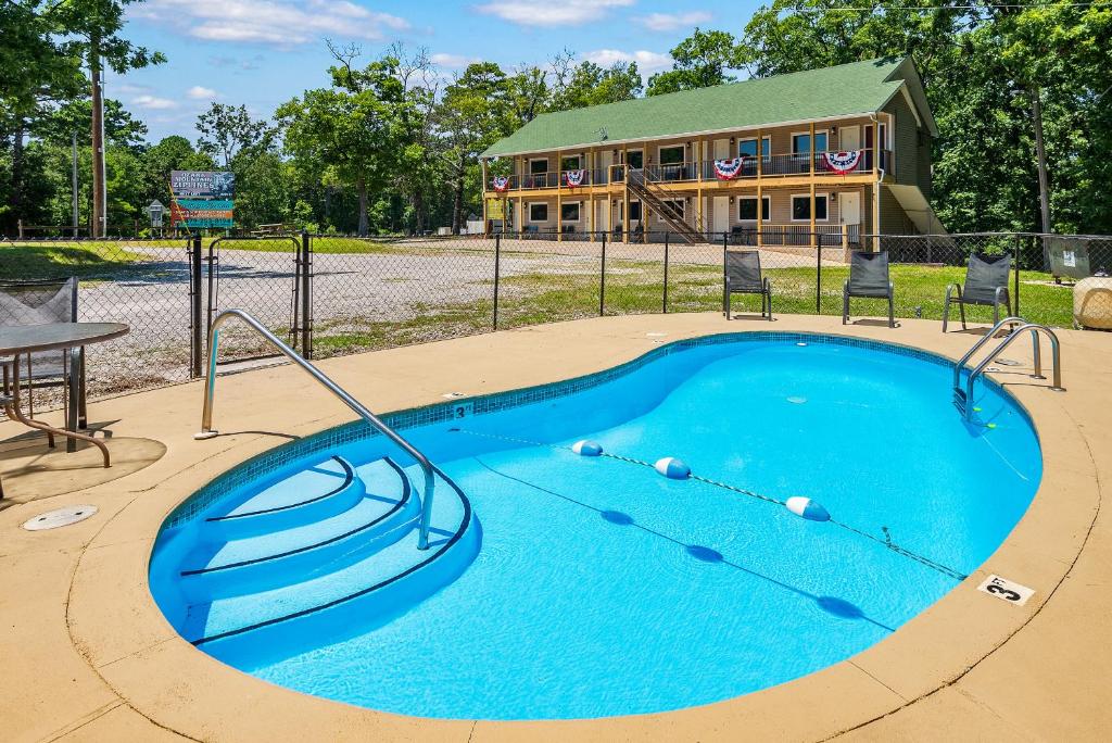 a swimming pool in front of a house at Trailhead Lodge in Eureka Springs