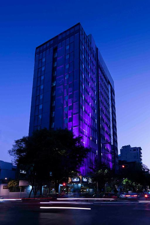 a building with purple lights on the side of it at LaiLa Hotel Mexico City Reforma in Mexico City