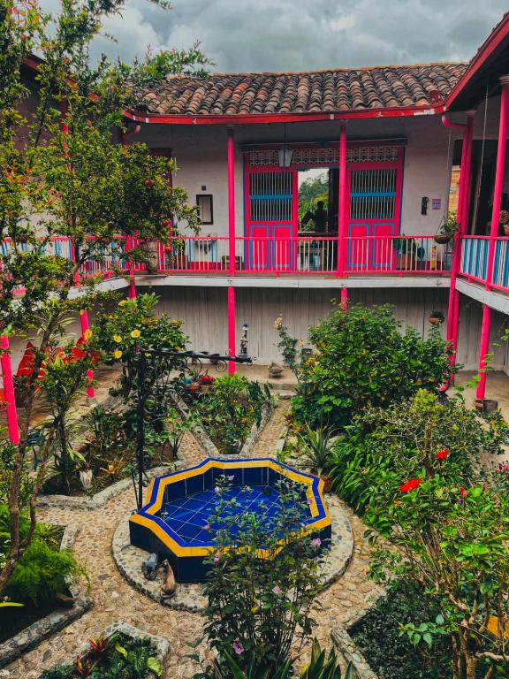 a house with a blue table in front of it at La Casa Rosada Hostel in Jericó