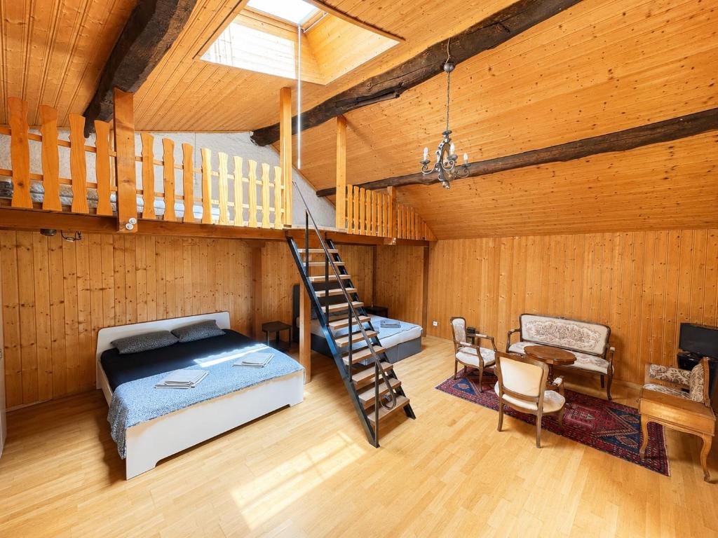 a bedroom with a bed and a staircase in a room at Casa Helvezia in Cadenazzo