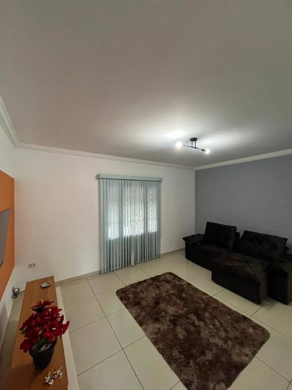 a living room with a couch and a table at Casa Carregosa in São Roque