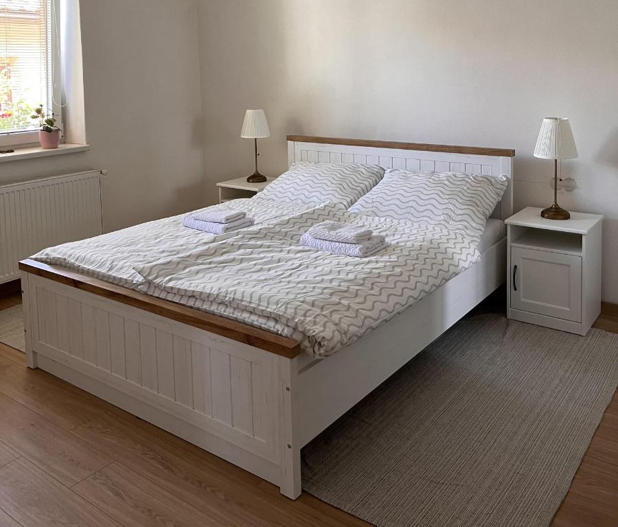 a bedroom with a white bed with two night stands at Linden House in Sklené
