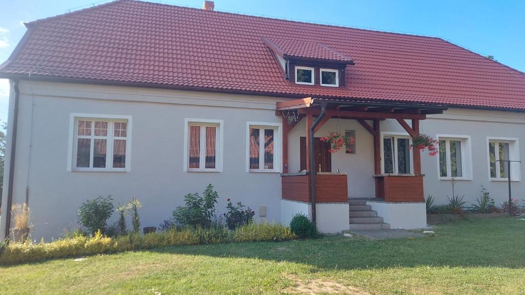 a white house with a red roof at KAM-TECH Krzysztof Kamiński in Krzywy Róg