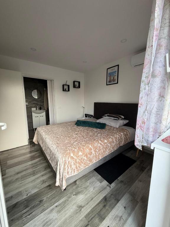 a bedroom with a bed and a wooden floor at Jetlag Bradić in Velika Gorica