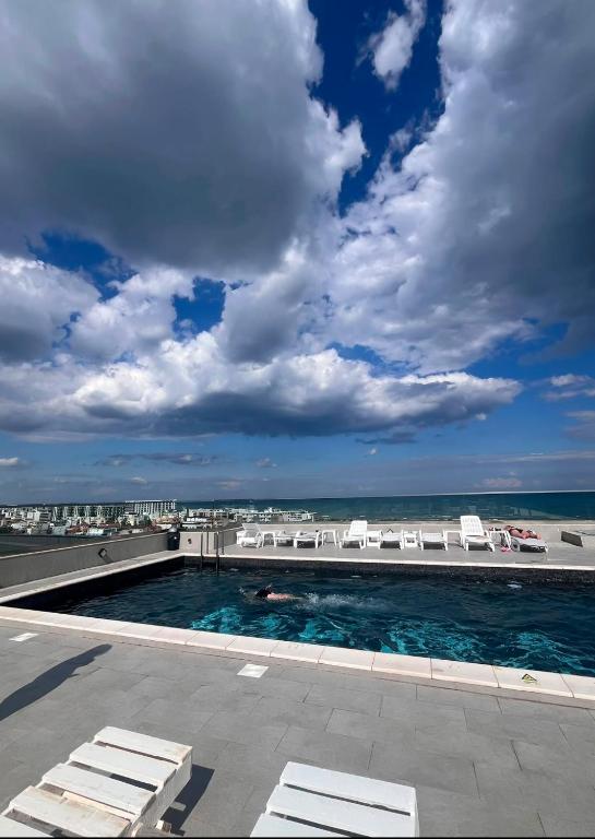 a swimming pool with a view of the ocean at Meraki Resort & Spa Isabellae Home in Mamaia Sat/Năvodari