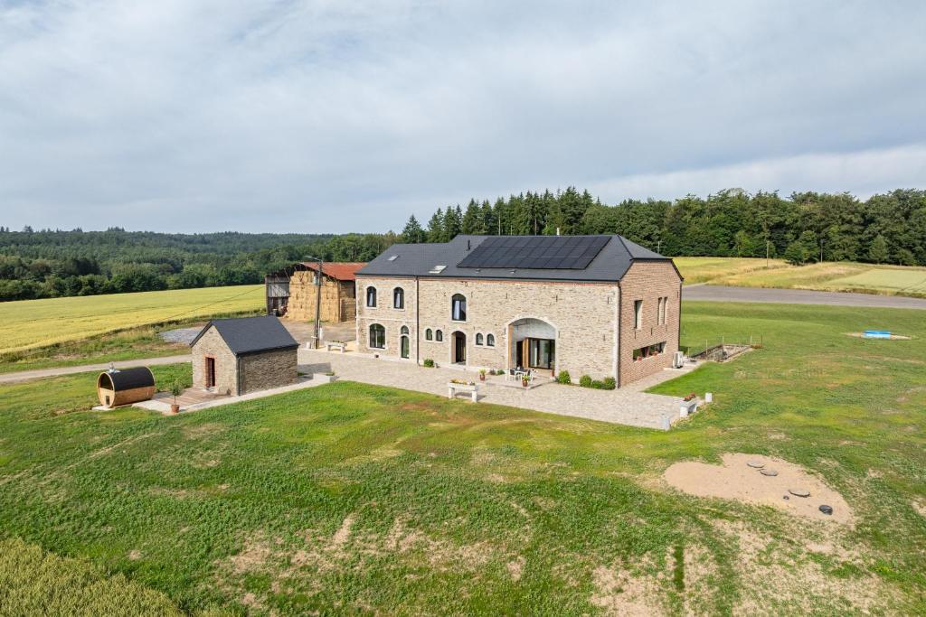 an aerial view of a large stone building in a field at Gîte de Thibautienne in Gedinne