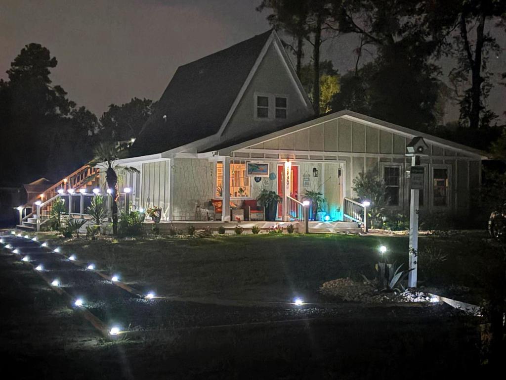 a house with lights in front of it at night at Sunset n Chill in Sunset Beach