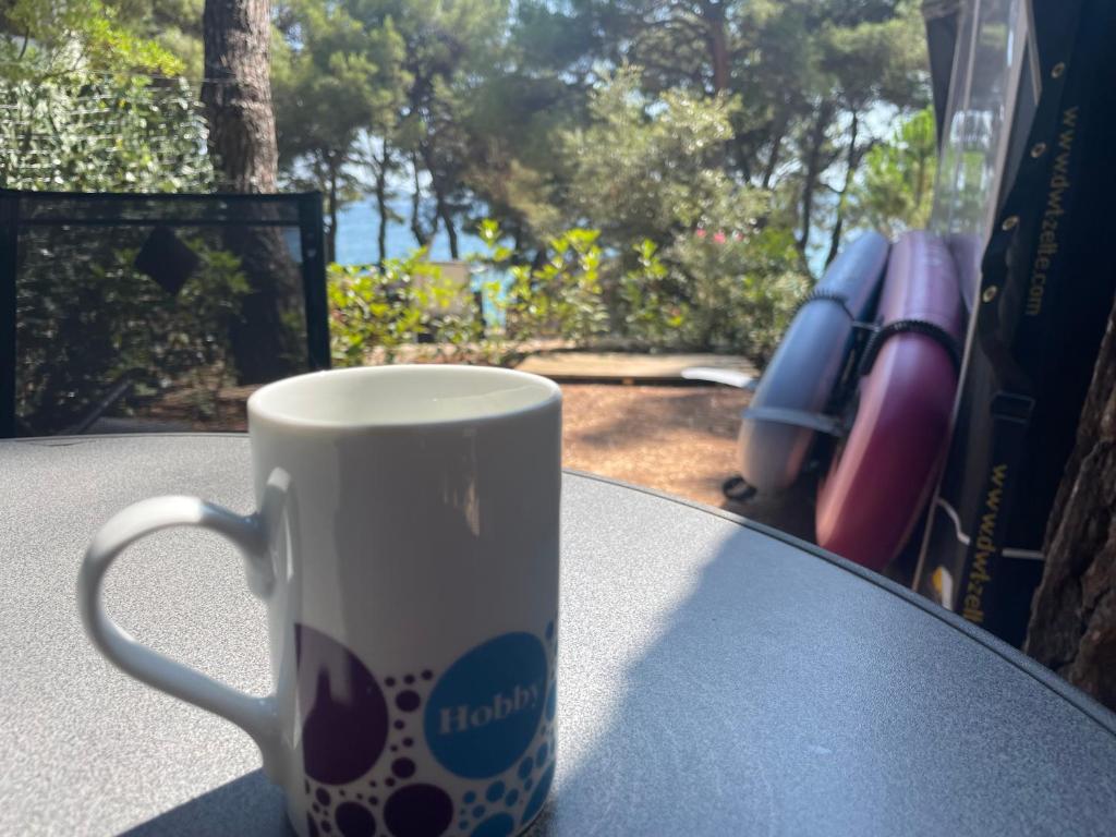 a coffee cup sitting on top of a table at SeaHouse Pakoštane - Hobby in Pakoštane