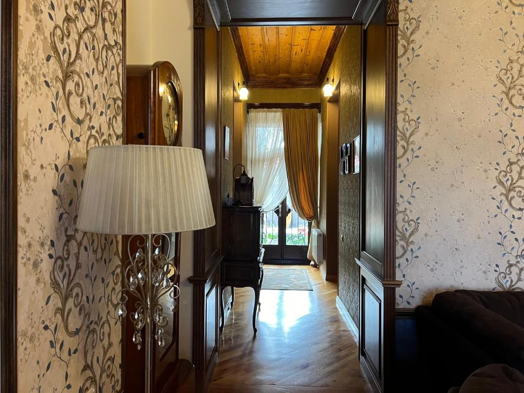 a living room with a lamp and a hallway at Gyumri Heritage House in Gyumri