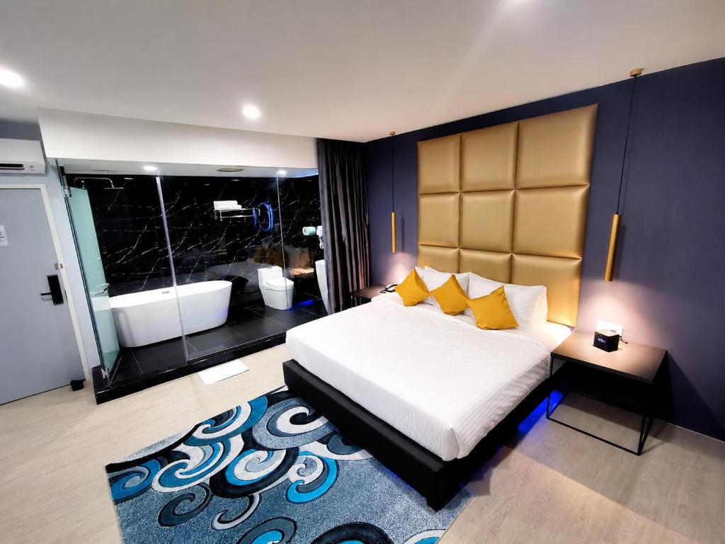 a bedroom with a large bed and a large rug at Hotel Wow Penang in George Town