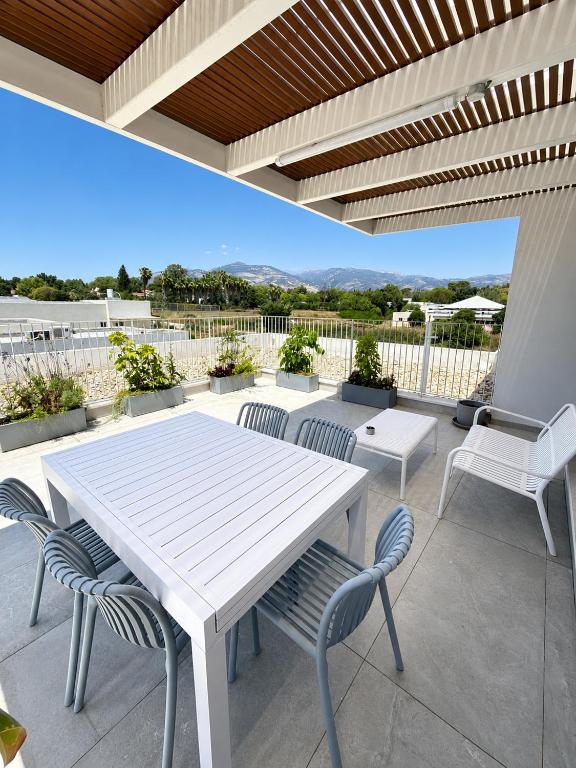 a white table and chairs on a patio at פלג טל -דפנה in Dafna