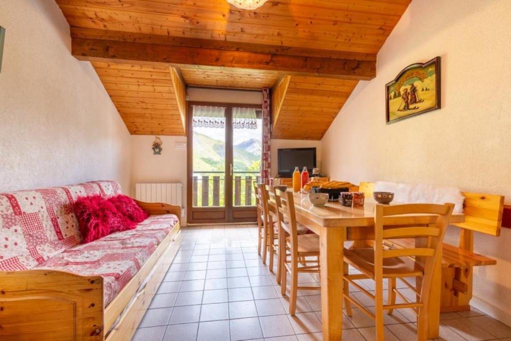 a living room with a couch and a table at Les Balcons de St So Appartement A in Saint-Sorlin-dʼArves