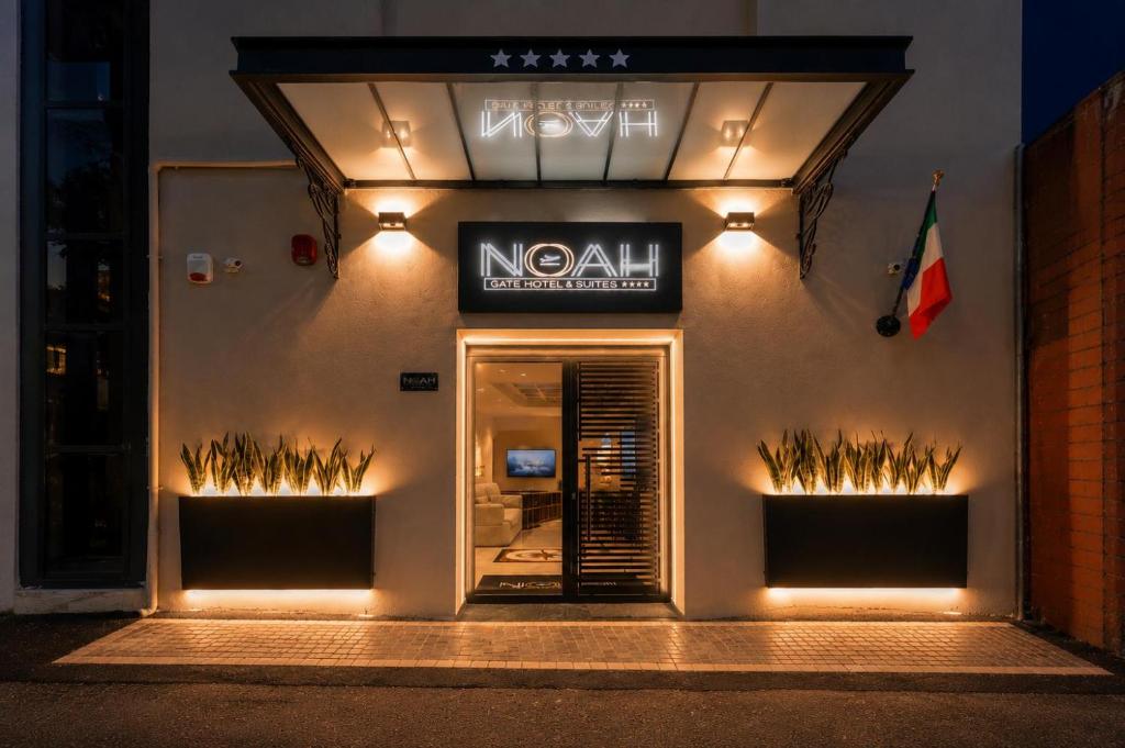 a noani restaurant with lights on the side of a building at Noah Gate Hotel & Suites in Naples