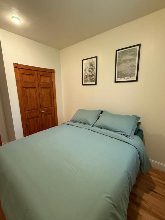 a bedroom with a large bed and a wooden door at Chic Times Square 1BR Entire Apt - Private Kitchen & Bath - Hosts 4 in New York