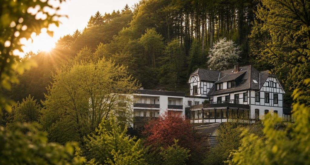 a house on top of a hill with trees at WELLNESS Hotel UHLENBERG in Bad Münstereifel