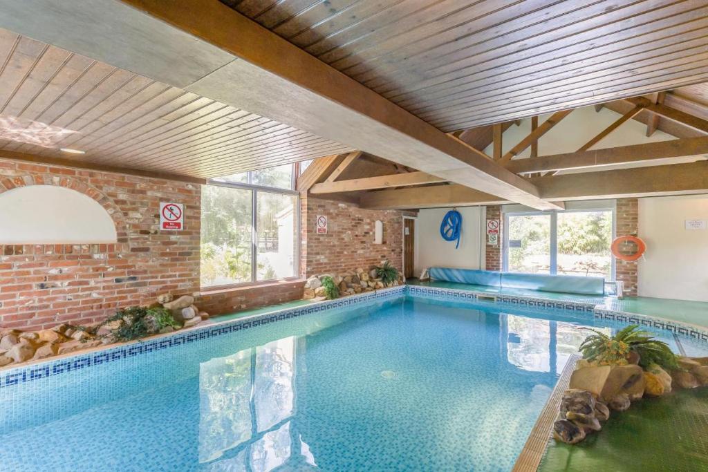 a large indoor swimming pool in a building at 3 Bed in Stratton Strawless oc-w34832 in Stratton Strawless