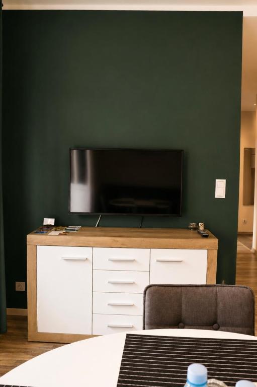 a flat screen tv sitting on top of a cabinet at Apartamenty ABRACADABRA in Ustroń