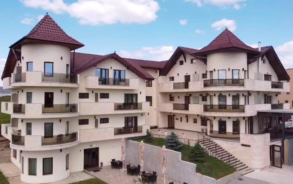 a large white building with turrets at Pensiunea Palace in Baile Felix