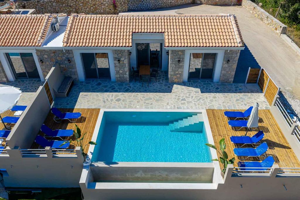 an aerial view of a house with a swimming pool at Tsoutsis Villas in Marantochori