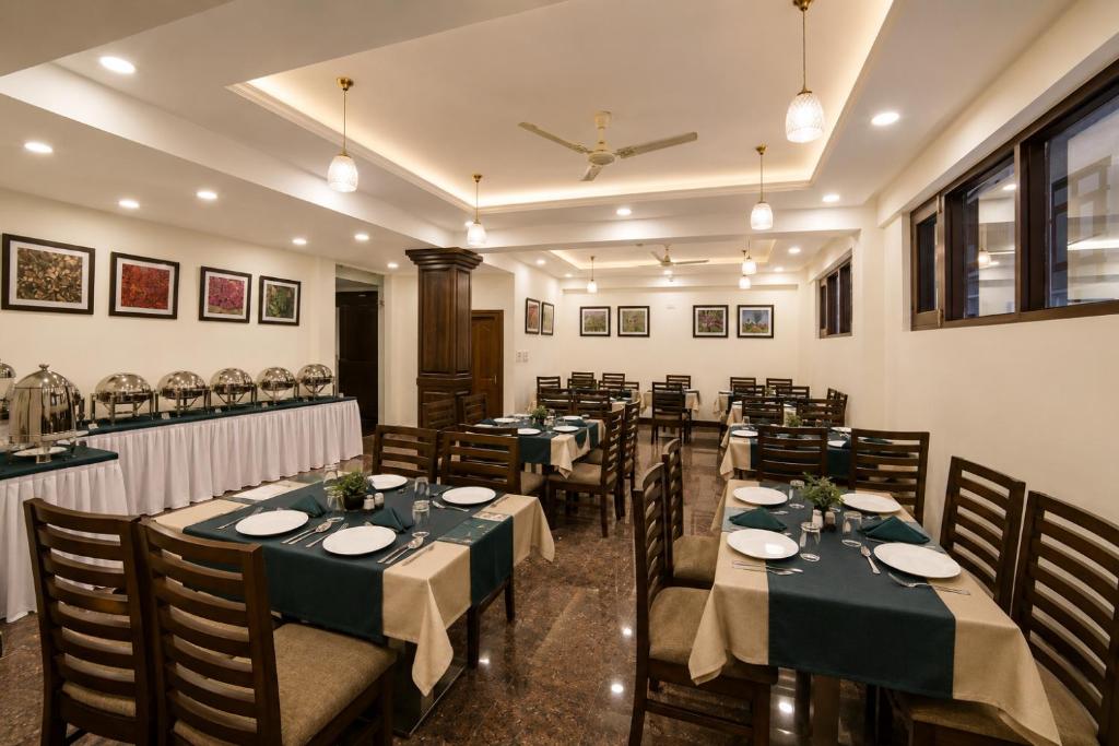 a restaurant with tables and chairs in a room at The Valley View in Srinagar