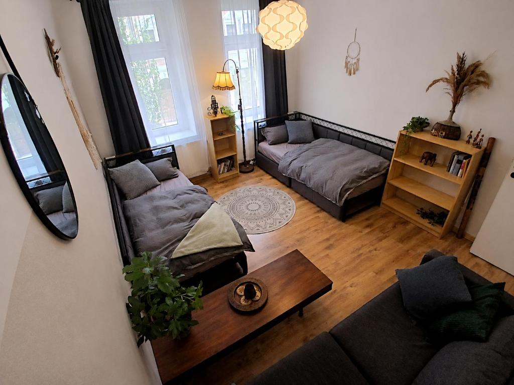 a living room with two couches and a table at The Boho Hideaway in Leutsch in Leipzig