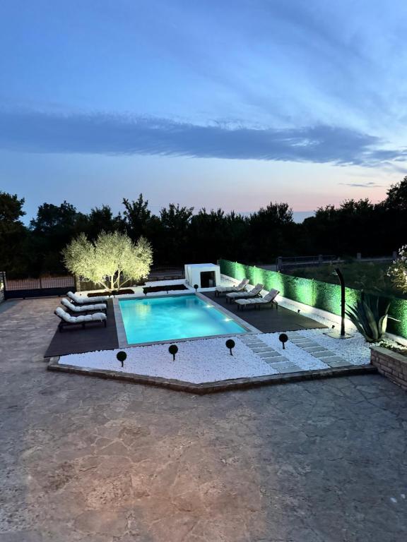 a swimming pool in a yard with lounge chairs at Villa Vuletic in Kula Atlagić