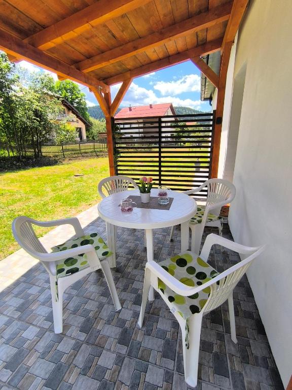 a white table and chairs on a patio at Vukašinova stanica in Pale