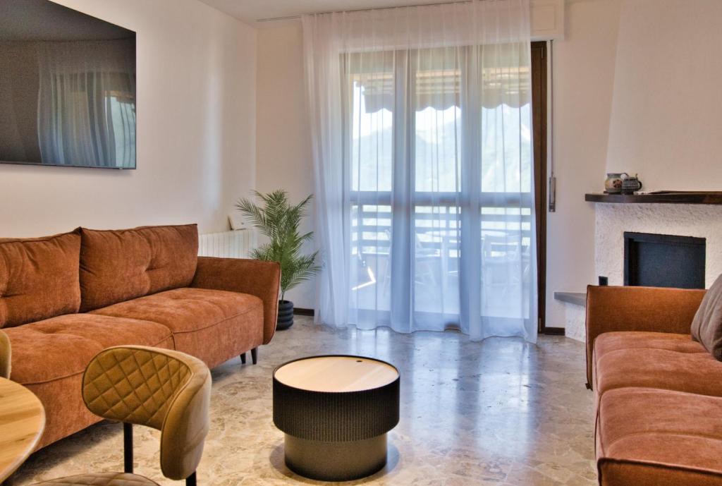 a living room with a couch and a table at Renzo e Lucia - la Terrazza Panoramica in Barzio