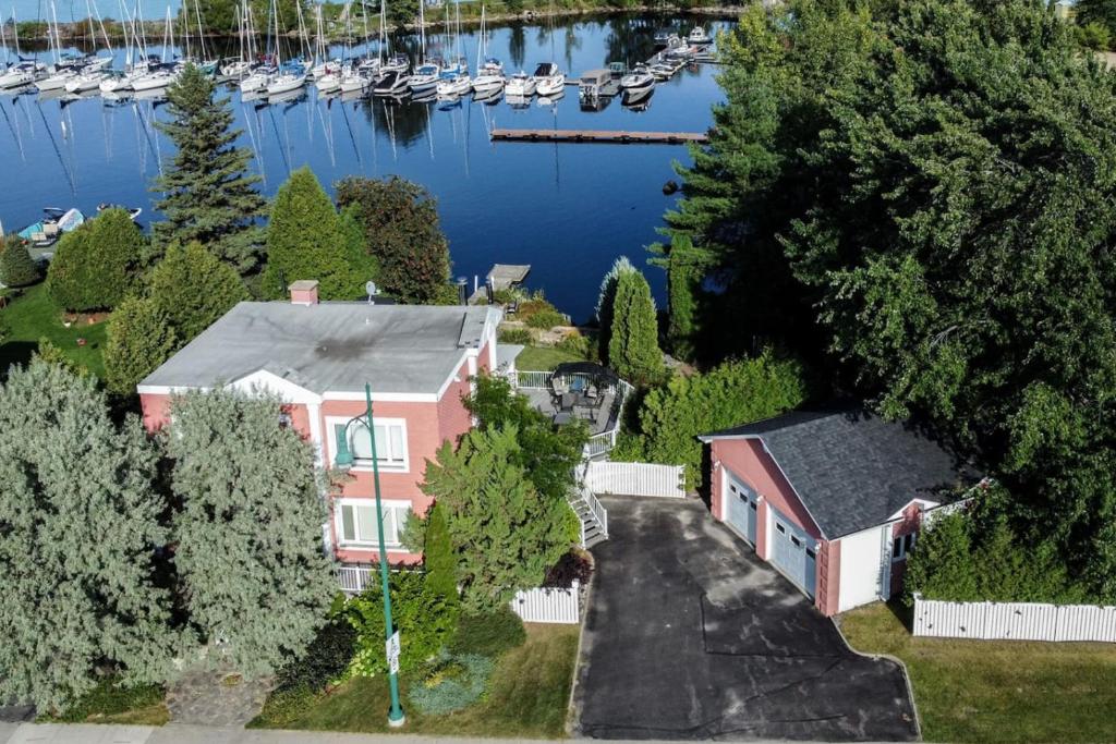 an aerial view of a house with a marina at La Perle Rose du Lac-St-Jean in Roberval