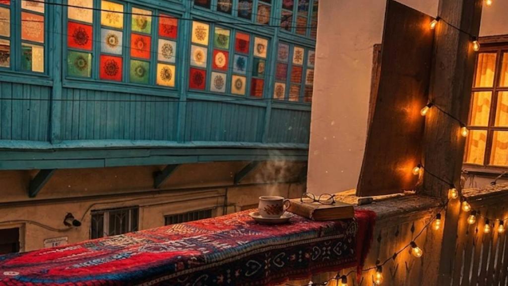 a room with a table with a coffee cup on it at Vintageshvili hostel and guest house in Tbilisi City