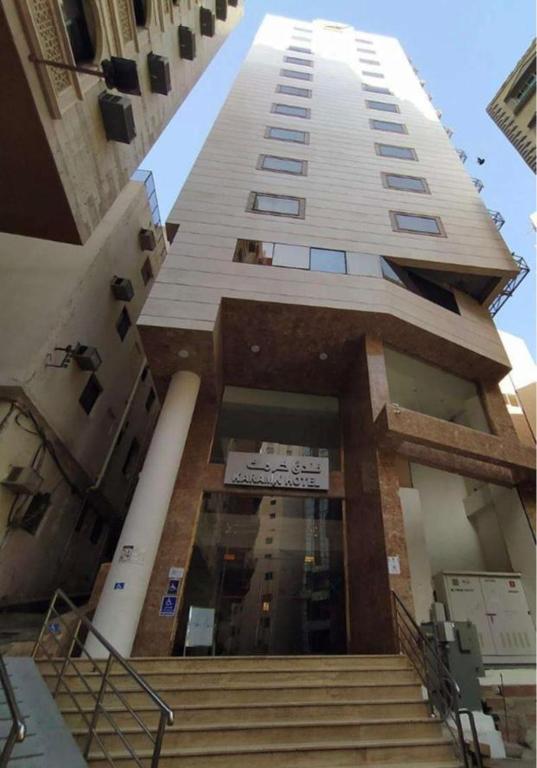 a tall building with stairs in front of it at فندق كرمك اجياد السد in Ajyad