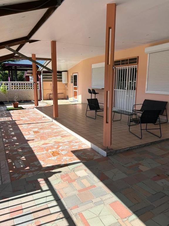 a patio with chairs and a table in a building at Villa R-A in Kourou