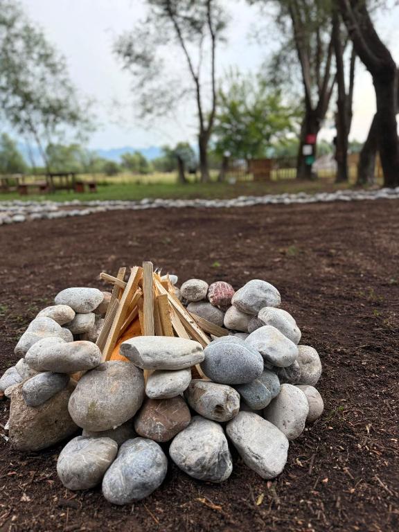 a pile of rocks on the ground in a park at Taverna e liqenit in Shtoji i Vjetër