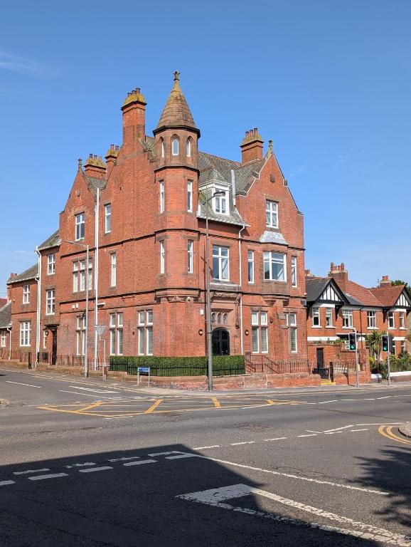 a large red brick building on a city street at The Old Bank in Warrenpoint