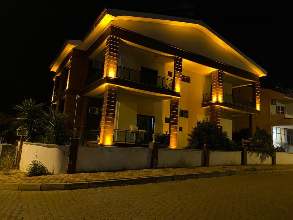 a house with lights on in front of it at night at The Selection Butik Otel in Kemer