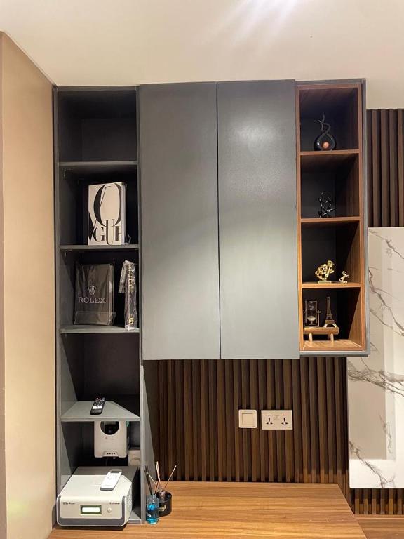 a room with a wall with shelves and a desk at Calia in Lagos