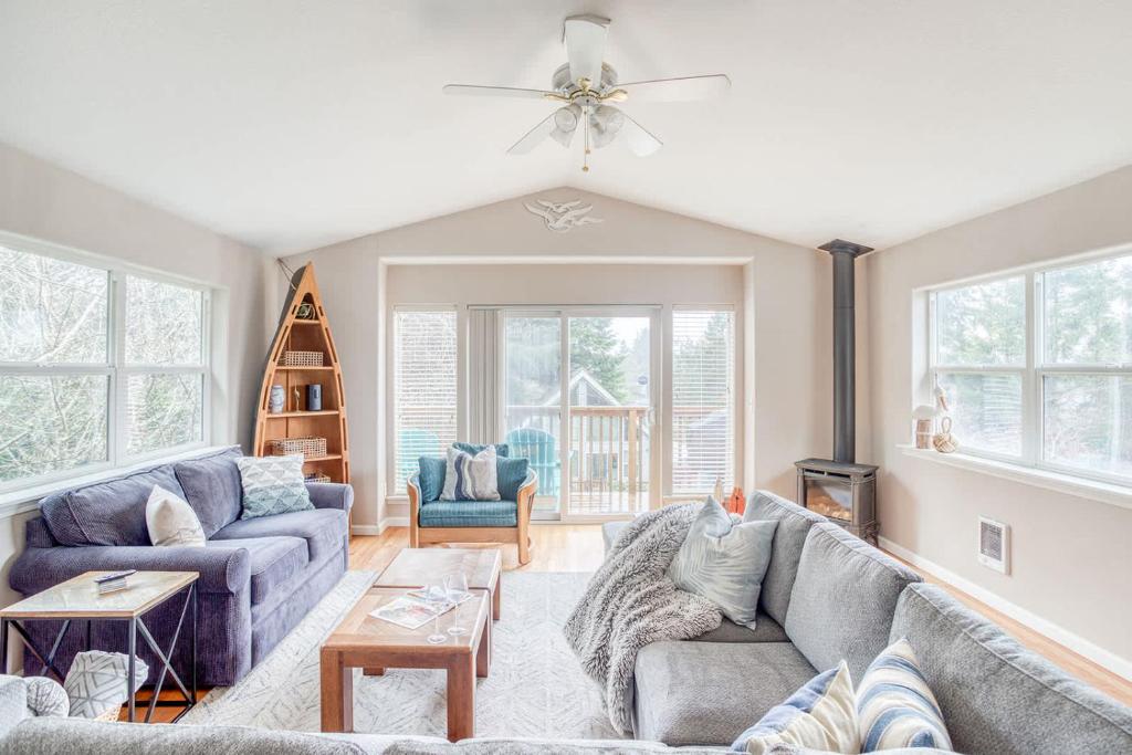 a living room with two couches and a fireplace at True North in Rockaway Beach