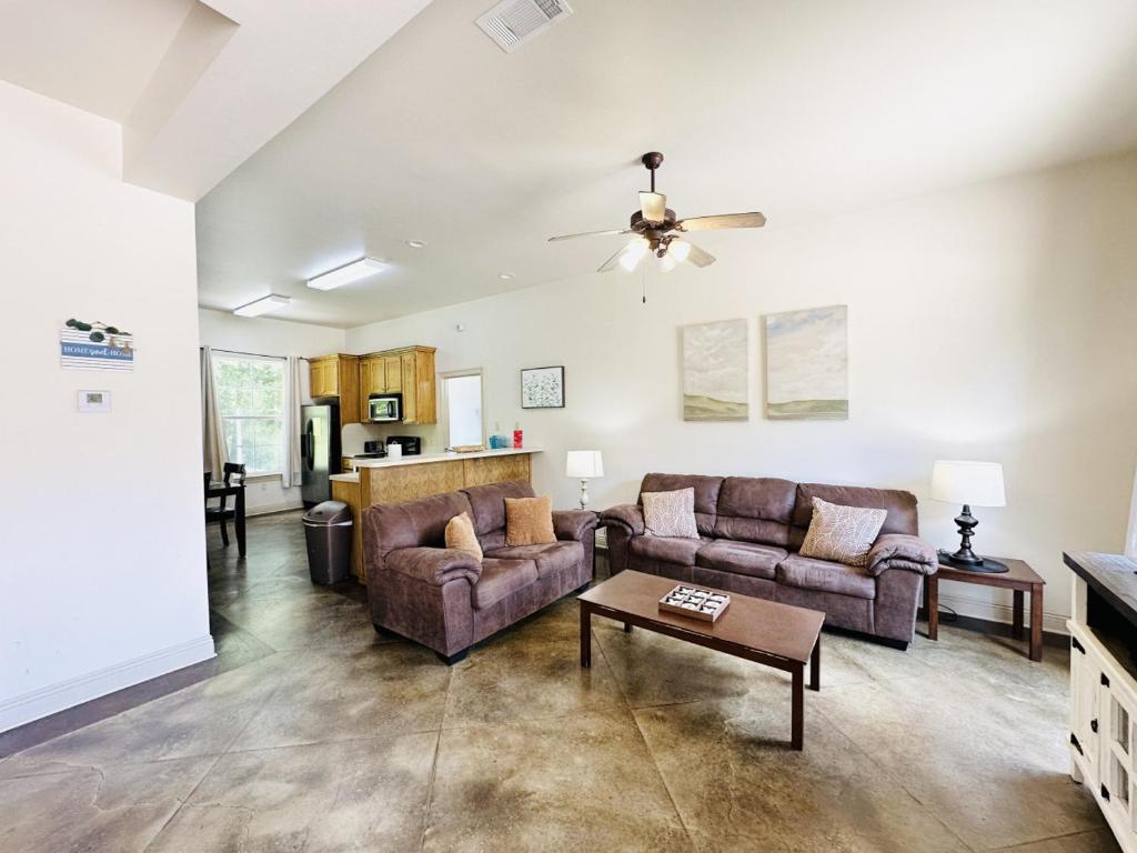 a living room with two couches and a table at Chateau 14 in Hammond