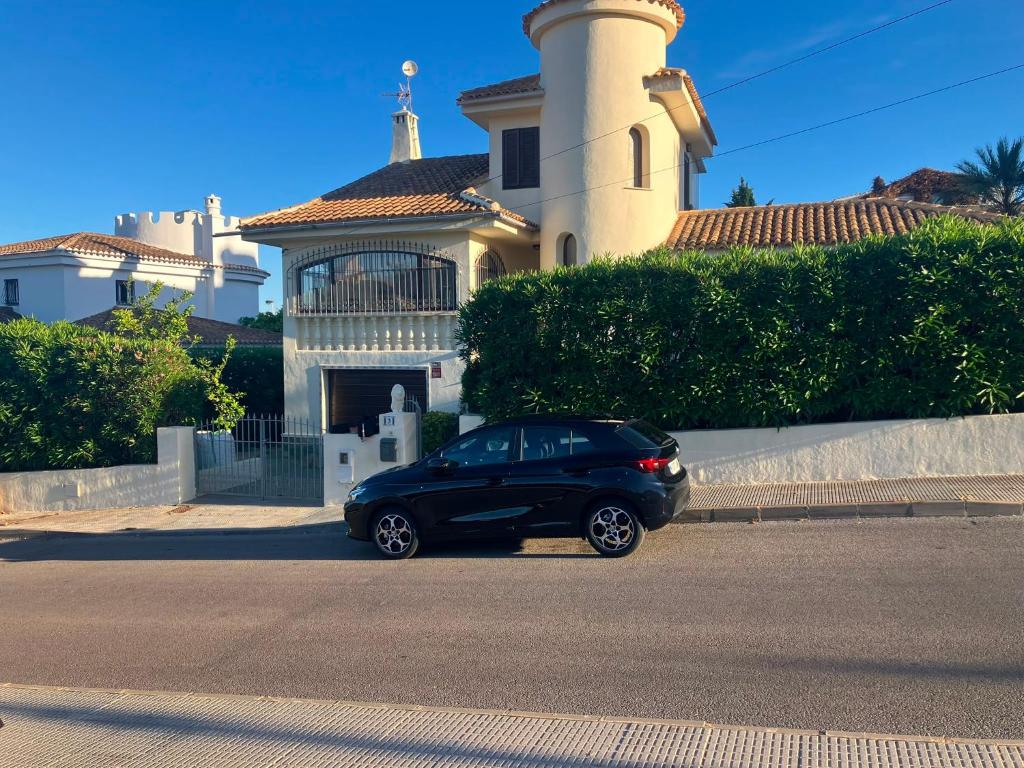 a car parked in front of a house with a lighthouse at Casa Leon Cabo de Palos Costa Calida La Manga Mar Menor Mittelmeer Alicante Cartagena in Cabo de Palos