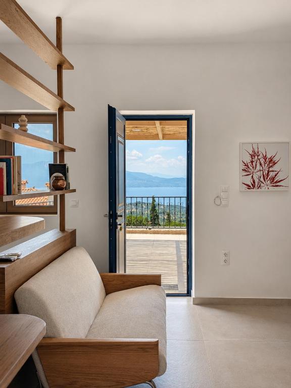 a living room with a couch and a sliding glass door at Trigono Suites - Karat in Politika