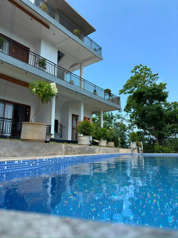 a swimming pool in front of a building at Cinnamon Ridge Unawatuna in Unawatuna