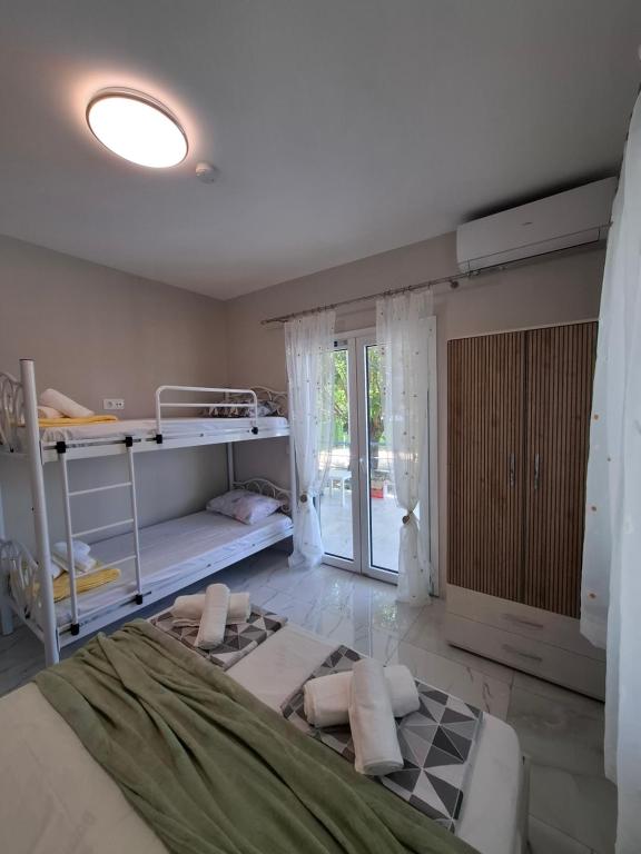 a bedroom with a bed and a large window at Zoya's house in Nea Kallikrateia