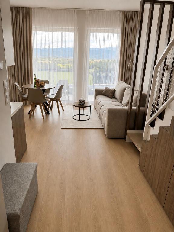 a living room with a couch and a table at Elite Gerlach Mezonet in Svätý Jur